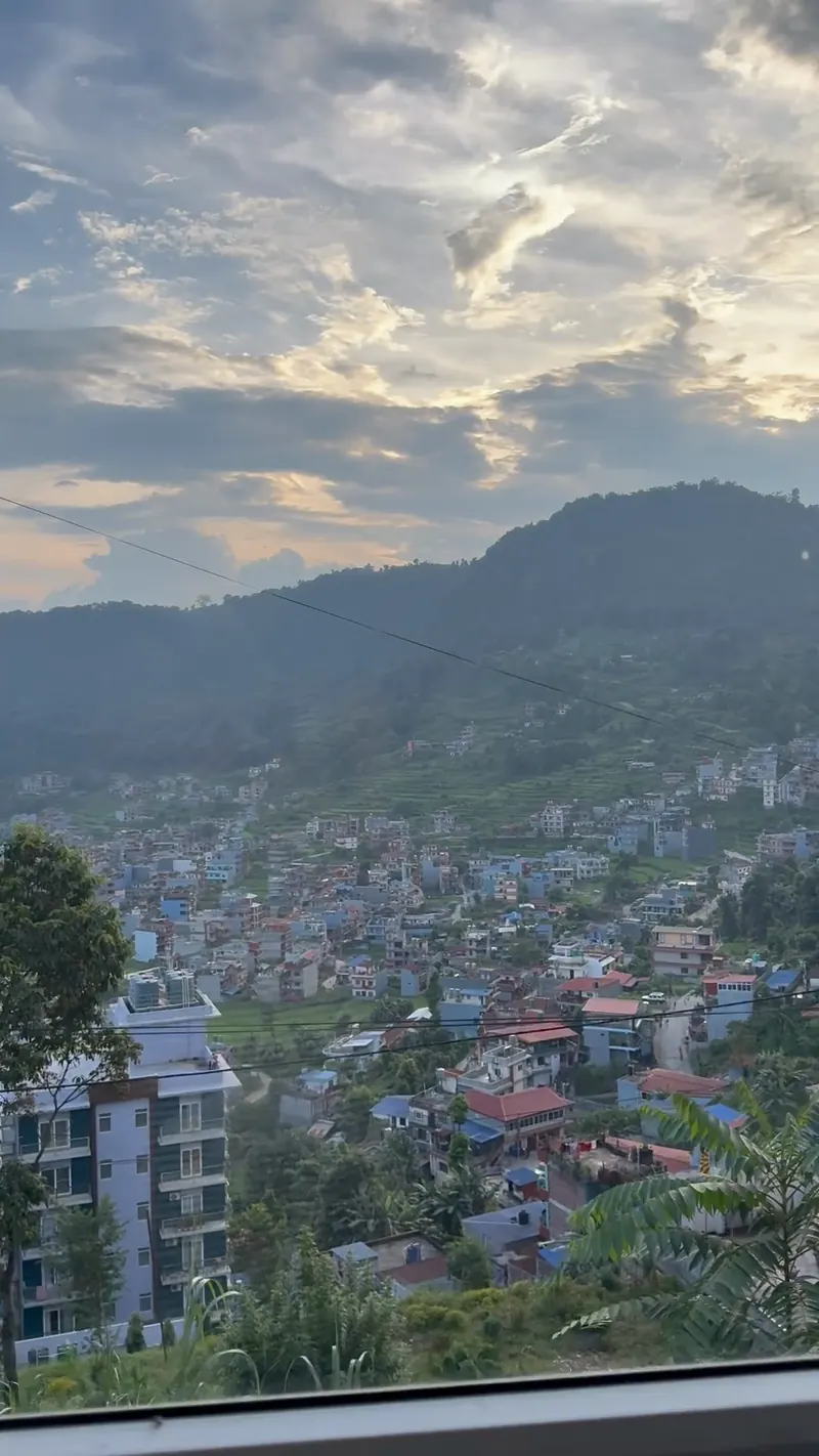 Pokhara valley at golden hour seen from a cabin window