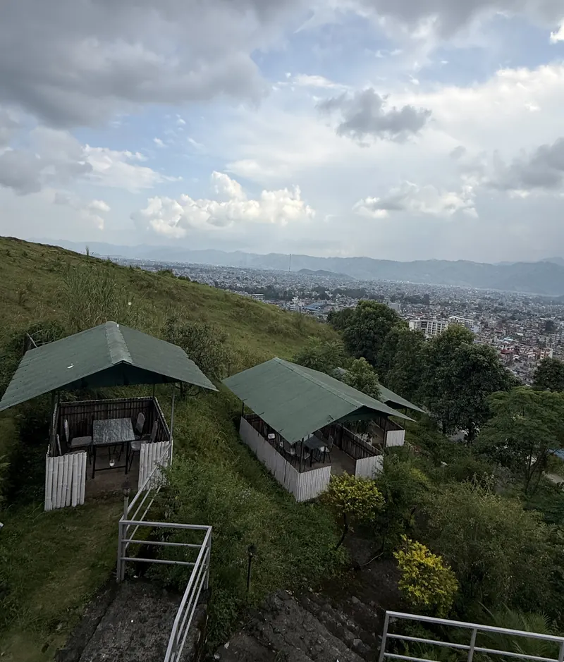 Green-roofed hillside cabins at The Lookout overlooking Pokhara